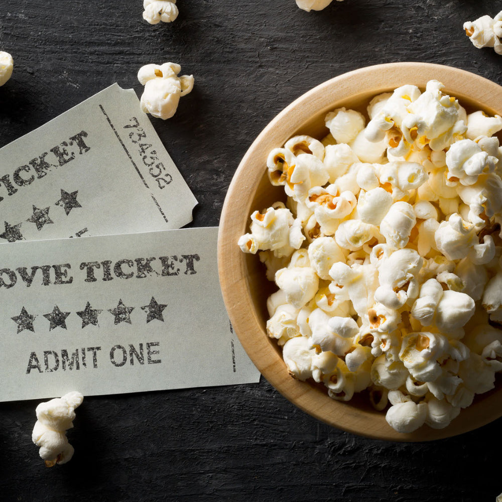 Bowl of popcorn and some movie tickets