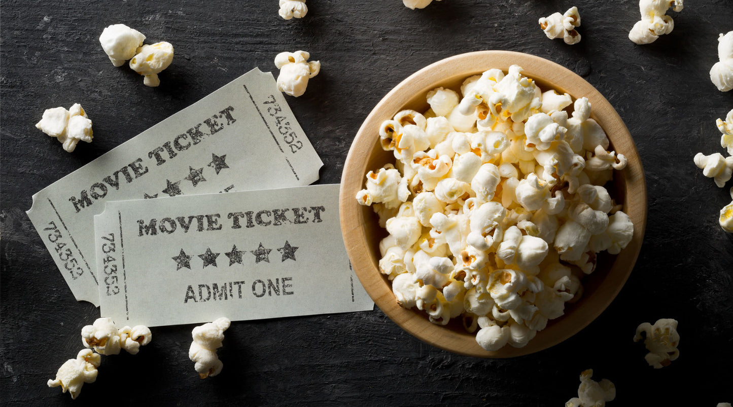 Bowl of popcorn and some movie tickets