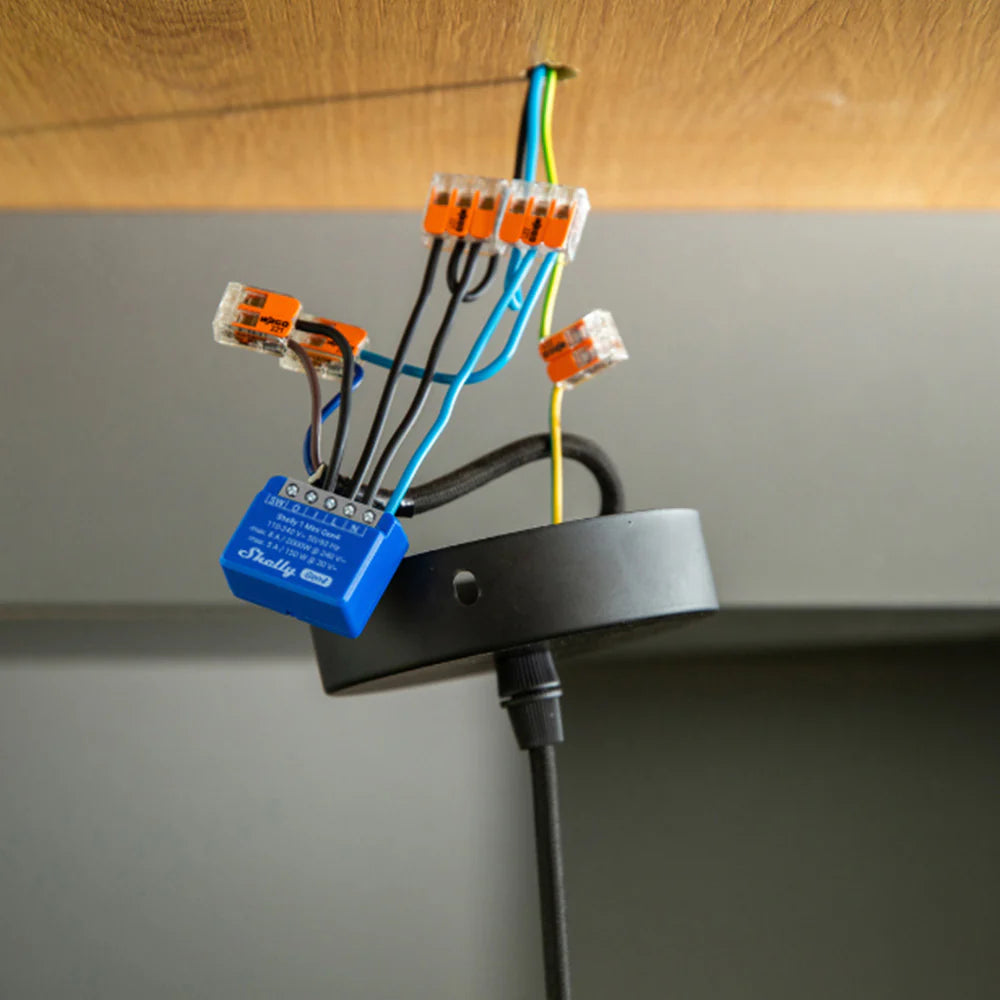 Shelly 1 Mini Gen 4 installed behind a light switch for space-saving smart control